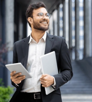 A confident Indian entrepreneur in a business suit.